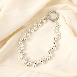 Detailed macro view of faceted silver metallic beads with a round spring clasp