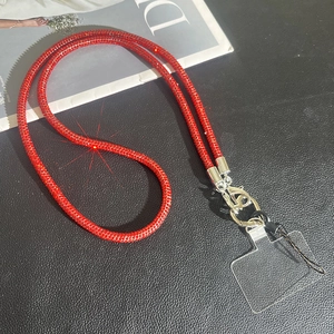 Close-up of luxury red rhinestone phone strap with silver metal lobster clasps