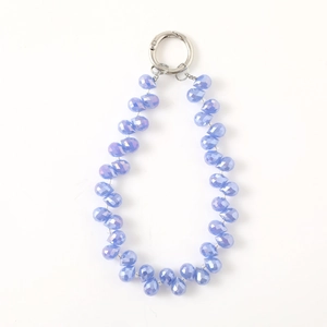 Elegant blue crystal teardrop beaded charm with silver metal ring clasp on white background