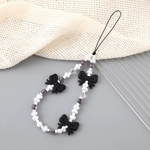 Handmade beaded phone strap with black bows, faux pearls and purple crystal beads