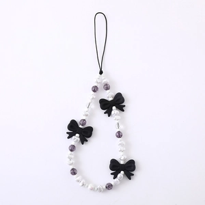 Beaded phone lanyard with white pearls, purple beads and black matte bows for a sweet cool style