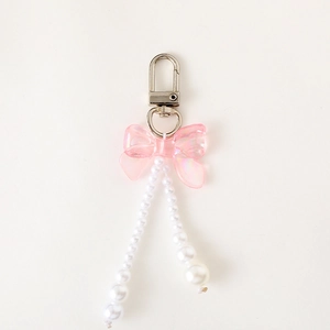 Charme de sac nœud rose avec perles dégradées et fermoir pivotant en argent