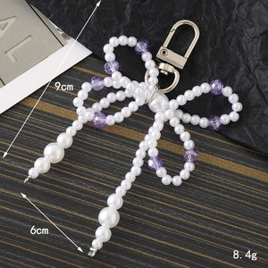Handmade pearl and purple bead bow charm with silver carabiner for bags or keys