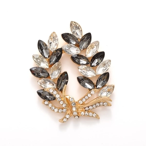 Elegant gold wheat ear brooch with marquise crystals and a sparkling rhinestone bow