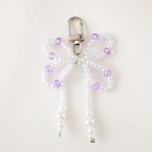 Fashionable bow beaded charm with white pearls and purple faceted beads for bags or cases