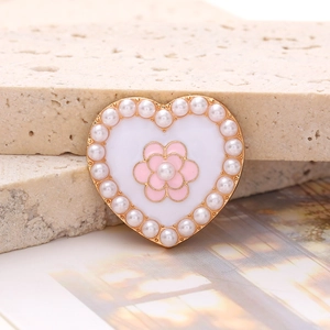 Elegant heart-shaped shoe charm with faux pearls and pink flower in golden finish