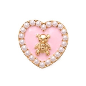 Pink enamel heart shoe charm with a golden bear and white pearls on a white background