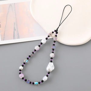 Detail of handmade beaded phone strap with baroque pearls and purple glass beads
