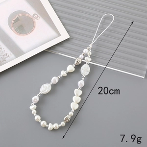 Beaded phone lanyard with pearls and silver heart charms on a textured grey background
