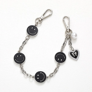Silver metal chain accessory with smiley faces and black heart charm for phone or bags