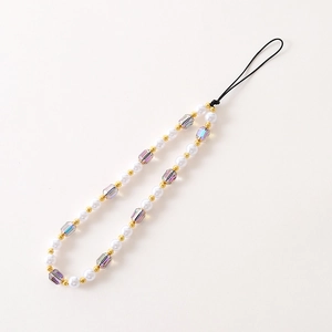 Detail of luxury pearl and crystal phone strap with faceted beads and gold metal accents