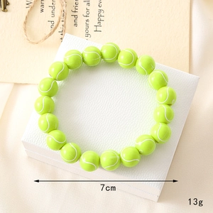Detailed view of a green tennis ball beaded bracelet with 7cm diameter and 13g weight