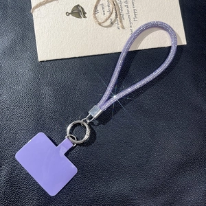 Detail of purple rhinestone tube lanyard with silver metal ring and phone connector tab