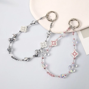 Elegant beaded four-leaf clover charms with shimmering crystals for bags and phone cases