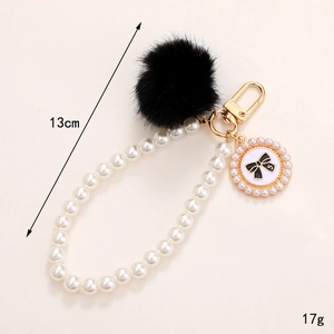 Pendentif en perles DIY avec boule en peluche noire et breloque noeud doré pour téléphone