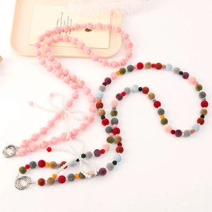 Crossbody phone lanyard with plush beads, pearl bow accent, and dual metal rings