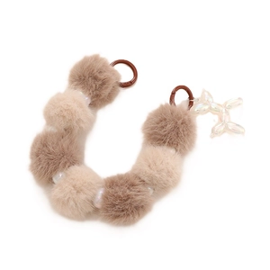 Faux fur pompom keychain with iridescent beads and balloon dog charm on white background
