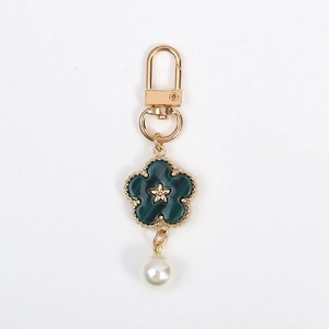 Golden flower keychain with green malachite texture petals and white pearl drop charm