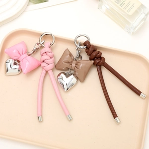 Pink and brown PU leather bow keychain with silver heart charm and twisted cord design
