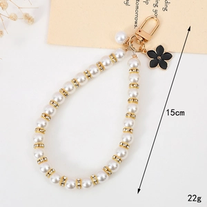 Elegant 15cm pearl phone strap with crystal rings and black enamel flower charm pendant