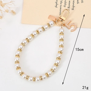 Short 15cm pearl phone strap with golden number 5 pendant and rhinestone accents