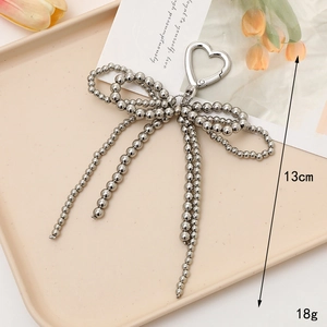 Silver beaded bow keychain with heart clasp, pearl-style tassel bag charm, 13cm length