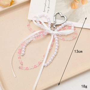 Elegant white pearl and pink beaded bow keychain with silver heart clasp and 13cm strap