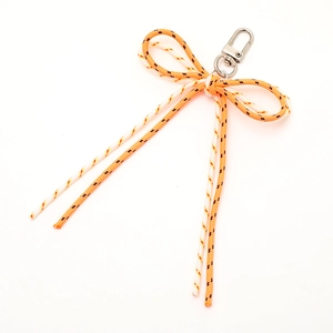 Colorful hand-woven bow keychain pendant with orange and white cord patterns