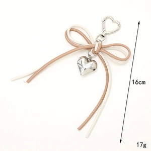 Minimalist cream and brown leather cord bow keychain with silver heart charm and clip