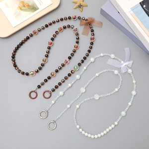 Crossbody pearl and crystal bead phone chain with elegant fabric ribbon bow and metal ring
