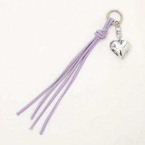 Lavender braided rope keychain with silver heart pendant and metal ring on white surface