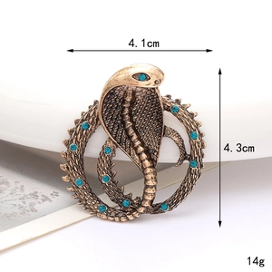 Vintage bronzen cobra slangenbroche met blauwe strassteentjes in een rond ontwerp