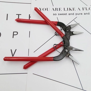 DIY jewelry tool set including metal wire cutters and round nose pliers with red handles