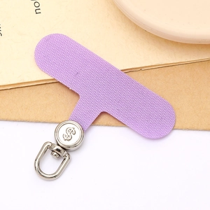 Macro shot of purple woven fabric phone tether tab with silver dollar sign metal swivel hook