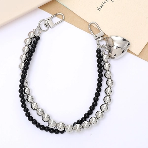 Dual-strand silver and black bead phone charm with a metallic heart pendant and clasps