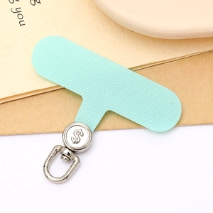 Detail of mint green T-shaped phone tether tab with silver rotating metal dollar sign clip