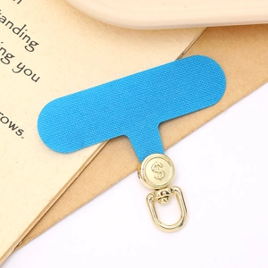 Sky blue phone strap pad with a rotating golden metal dollar sign clip on a desk