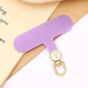 Detail of purple woven phone lanyard patch with golden rotating dollar sign metal buckle