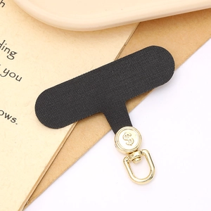 Black fiber phone tether tab with golden rotating metal buckle and dollar sign detail