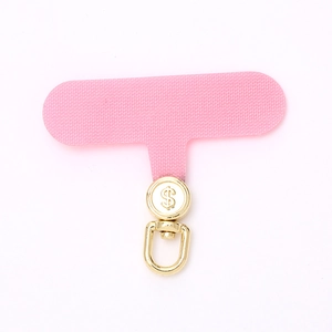 Pink fabric phone tether tab with golden rotating dollar sign metal hook and mesh texture