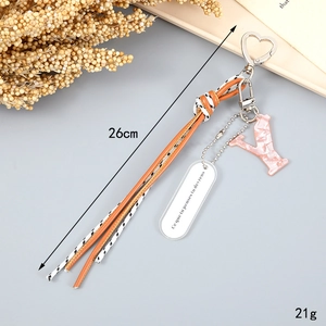 Detail of braided rope keychain with letter Y and orange leather tassel 26cm length