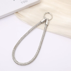 Close-up of sparkling silver rhinestone phone strap with a metal spring buckle detail