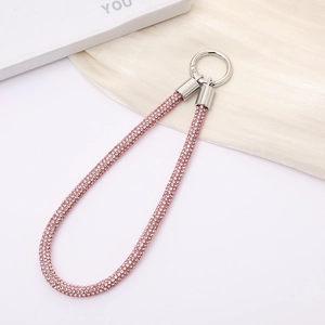 Elegant pink rhinestone phone wrist strap with silver metal ring on white display board