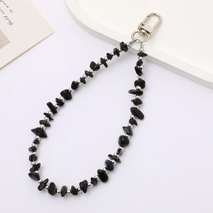 Detailed view of black natural stone beads with silver spacers and swivel lobster clasp