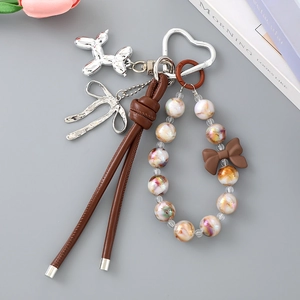 Detail of beaded keychain with silver balloon dog pendant and leather strap accessory