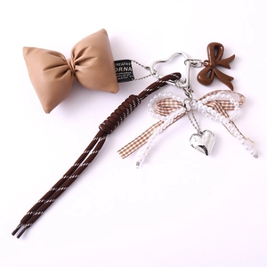 Brown woven rope bag charm with heart pendant, pearl bow, and PU leather bow