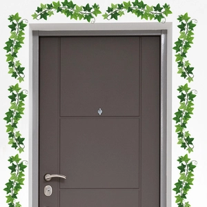 Detail of green ivy leaf wall stickers decorating a wooden door frame for home decor
