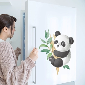 Detail of cartoon panda wall sticker on white fridge in a modern home kitchen setting