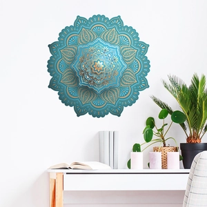 Detailed teal and gold mandala wall decal applied on white wall in a modern room setting