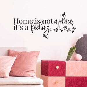Living room decor with 'Home is not a place it's a feeling' black vinyl wall sticker